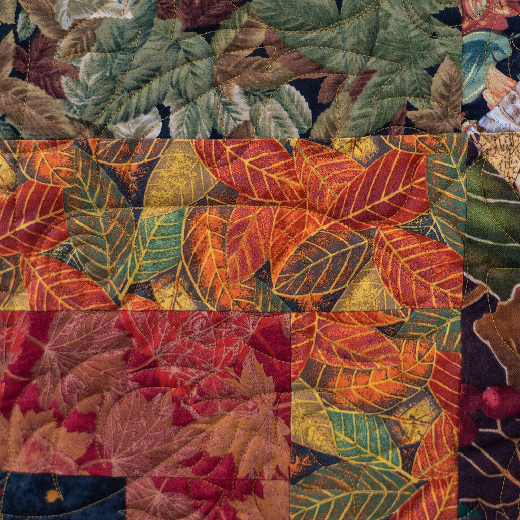 Quilt block with large leaf prints in autumnal colours.