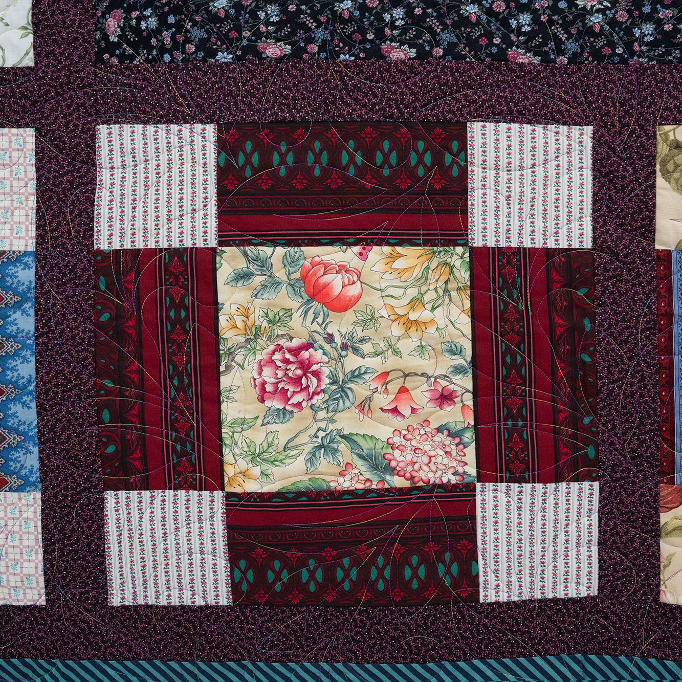 Patchwork quilt with various patterns and colors on a dark background