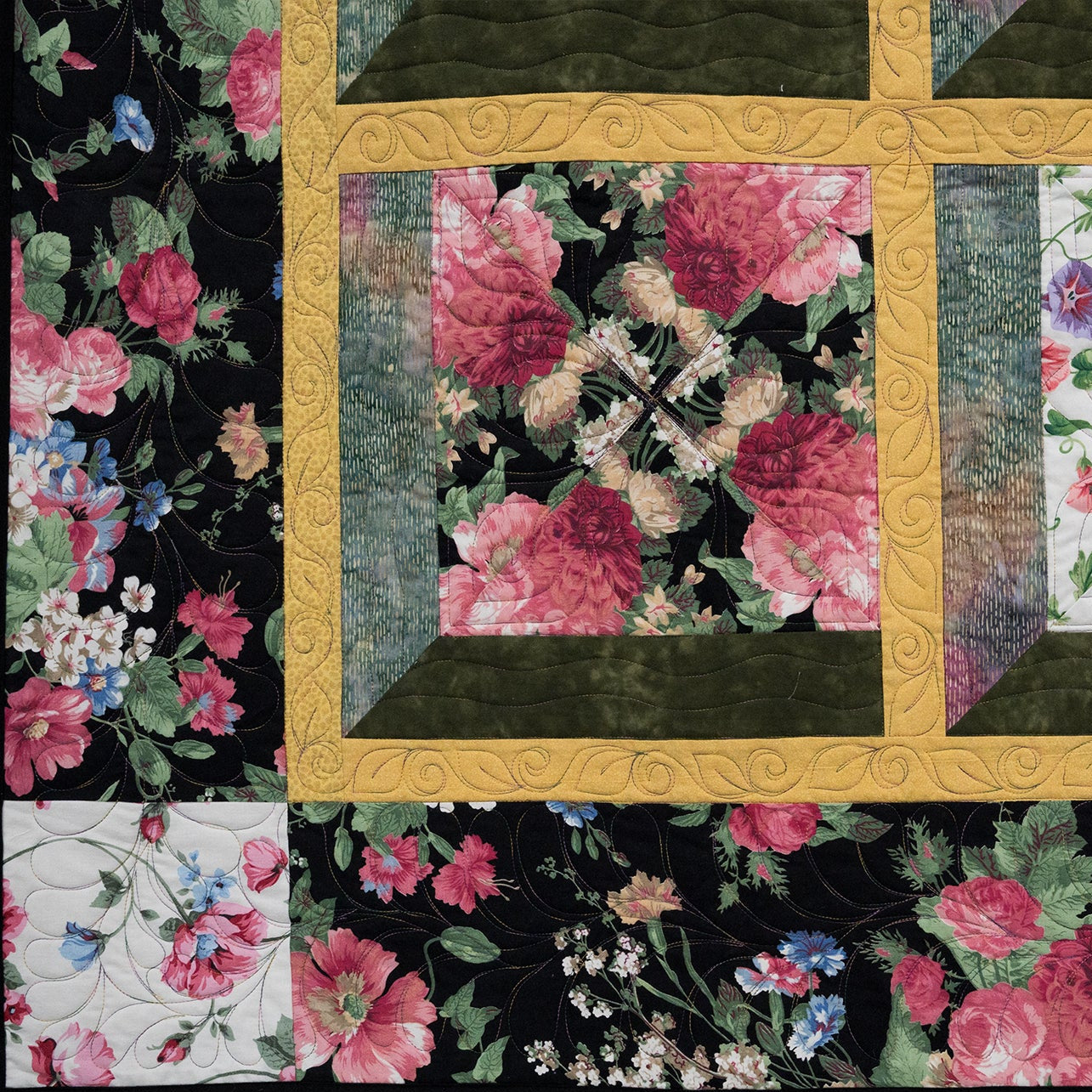 Floral quilt with a black background featuring pink and white flowers.