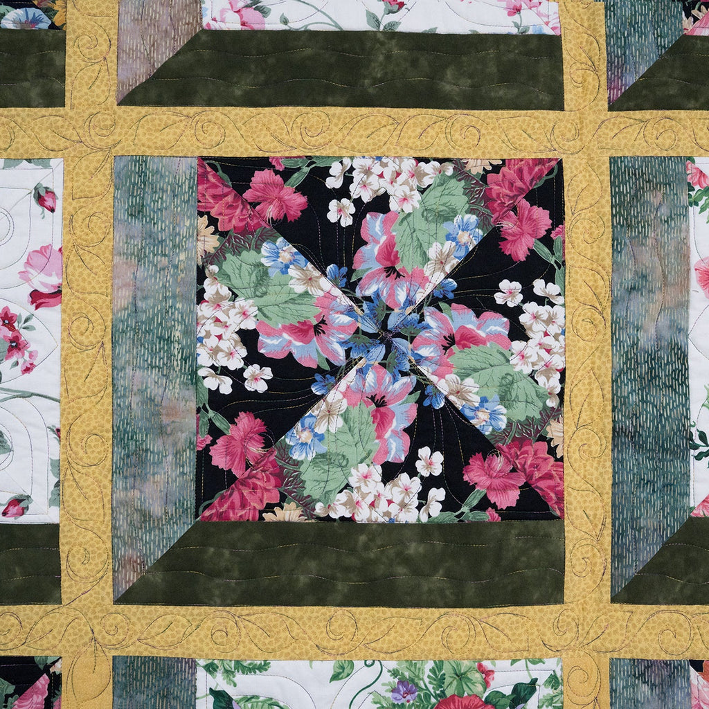 Quilt with floral patterns in a grid layout