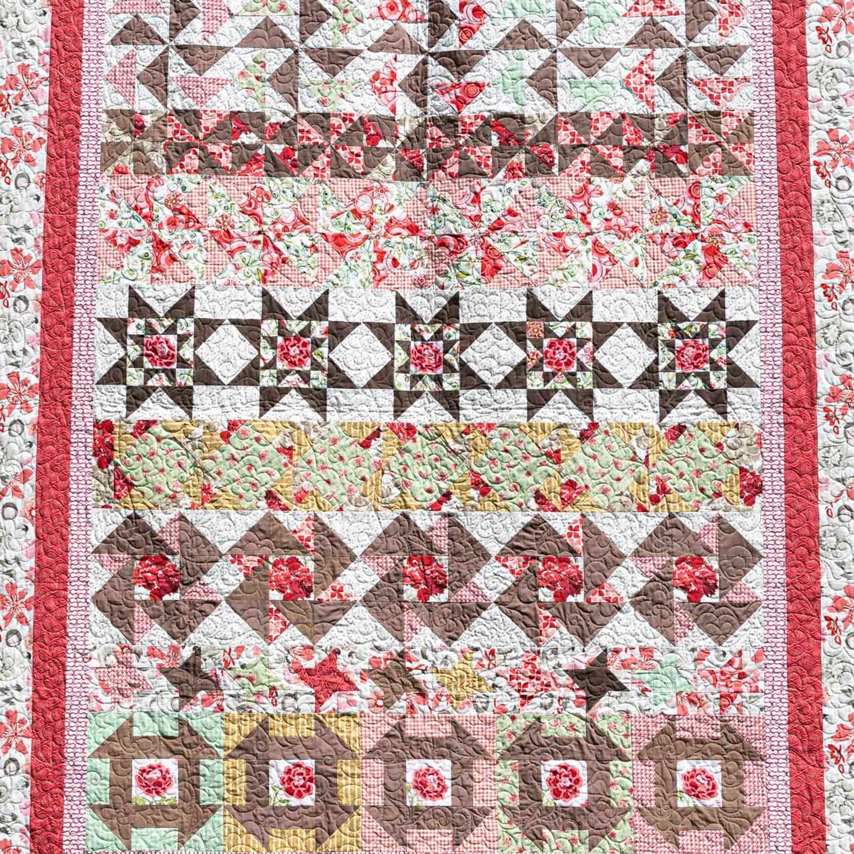 Quilt with floral and geometric patterns