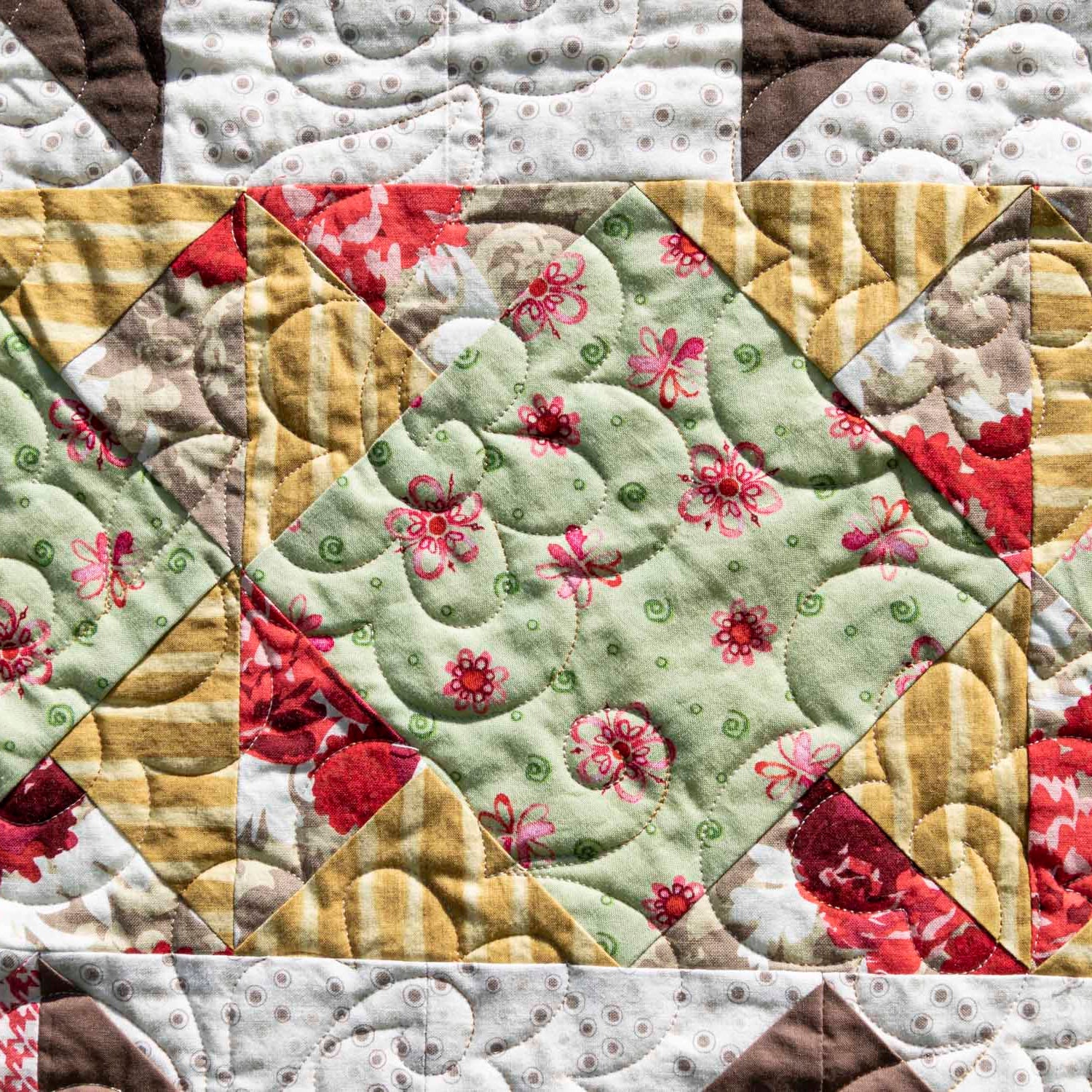 Close-up of a patchwork quilt with floral patterns