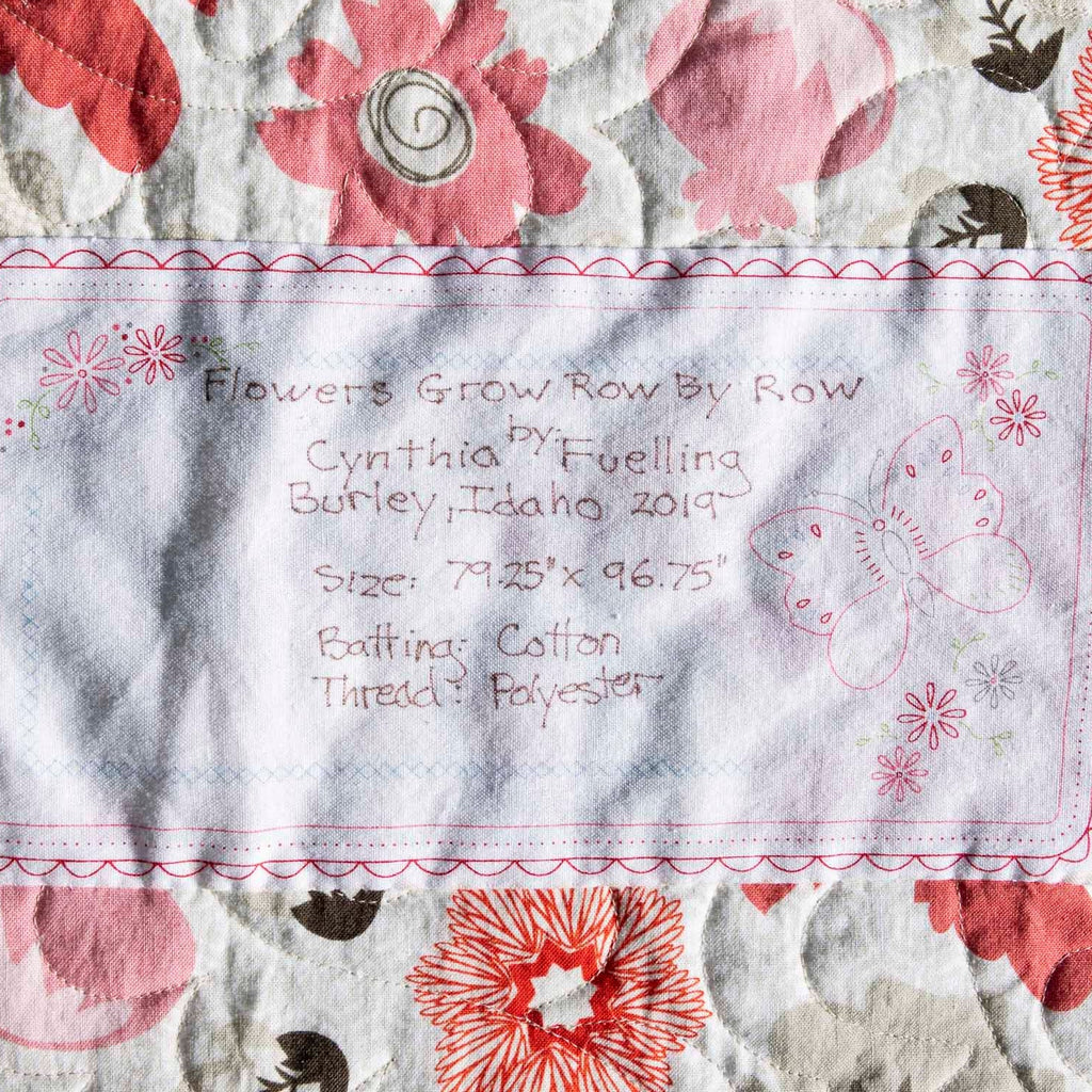 Floral patterned fabric with embroidered text and designs