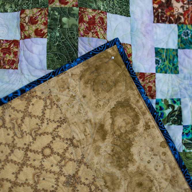 Close-up of a patchwork quilt with various patterns and colors.