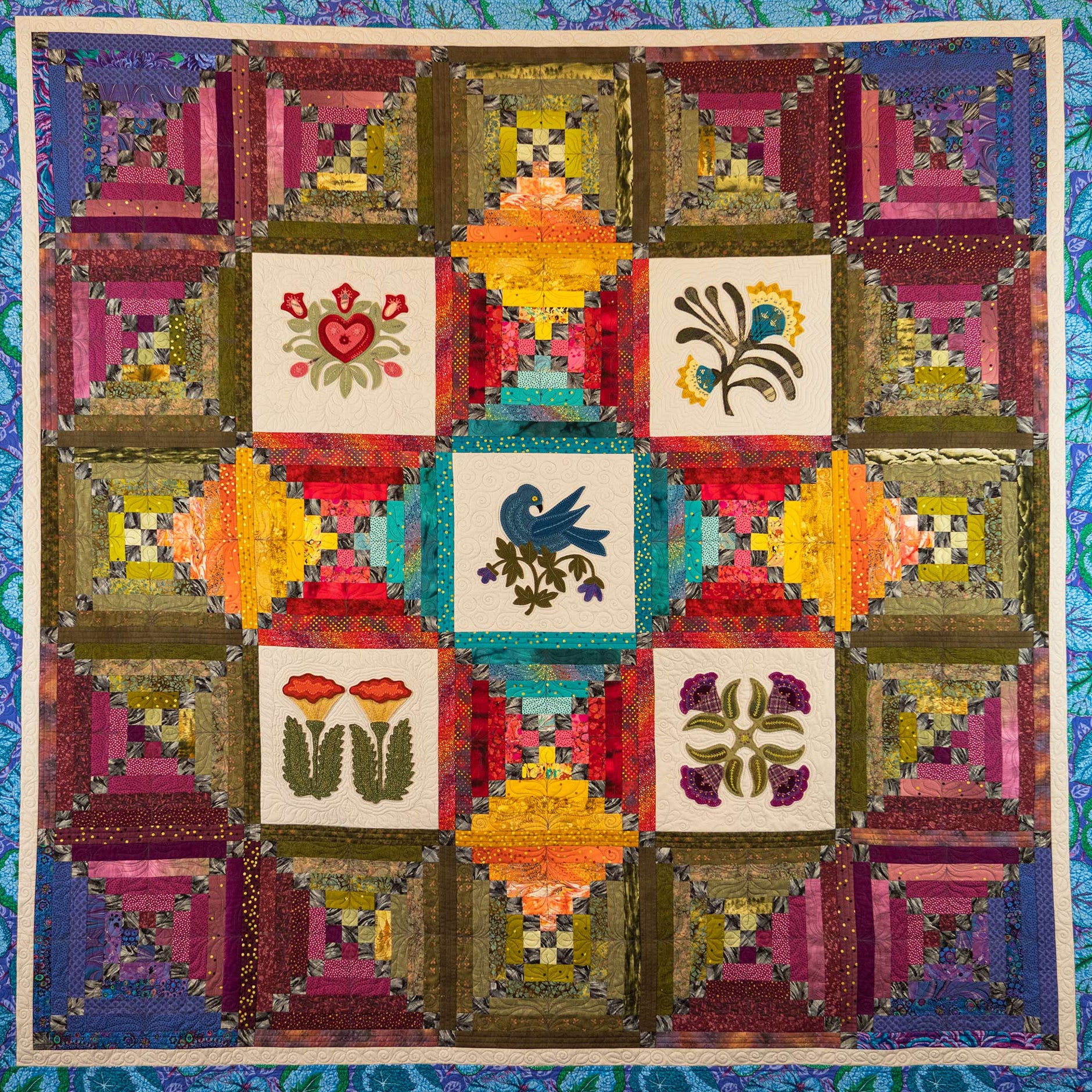 Colourful quilt with a diamond layout laid out flat