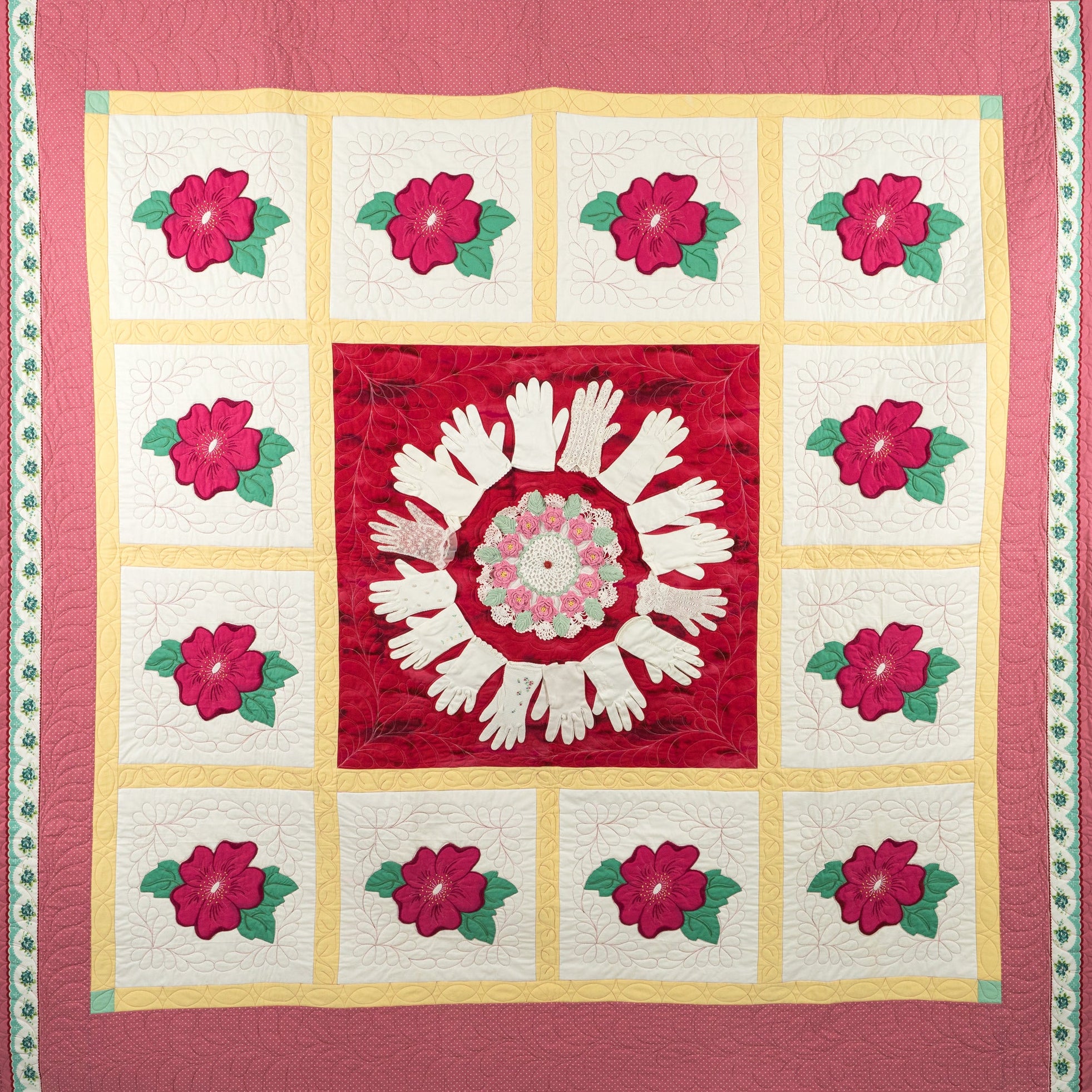 Quilt with floral pattern and central design on a red background