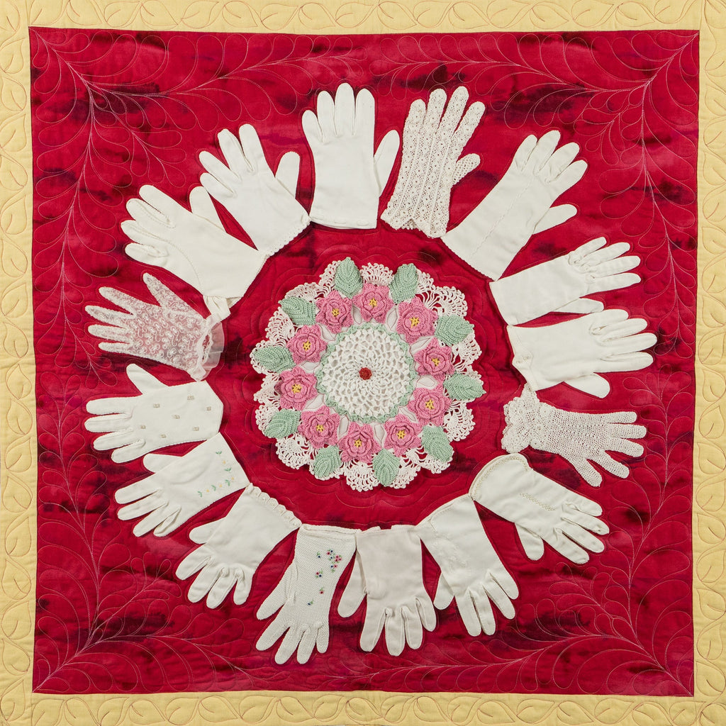 Artistic arrangement of white gloves and floral center on a red background with gold border