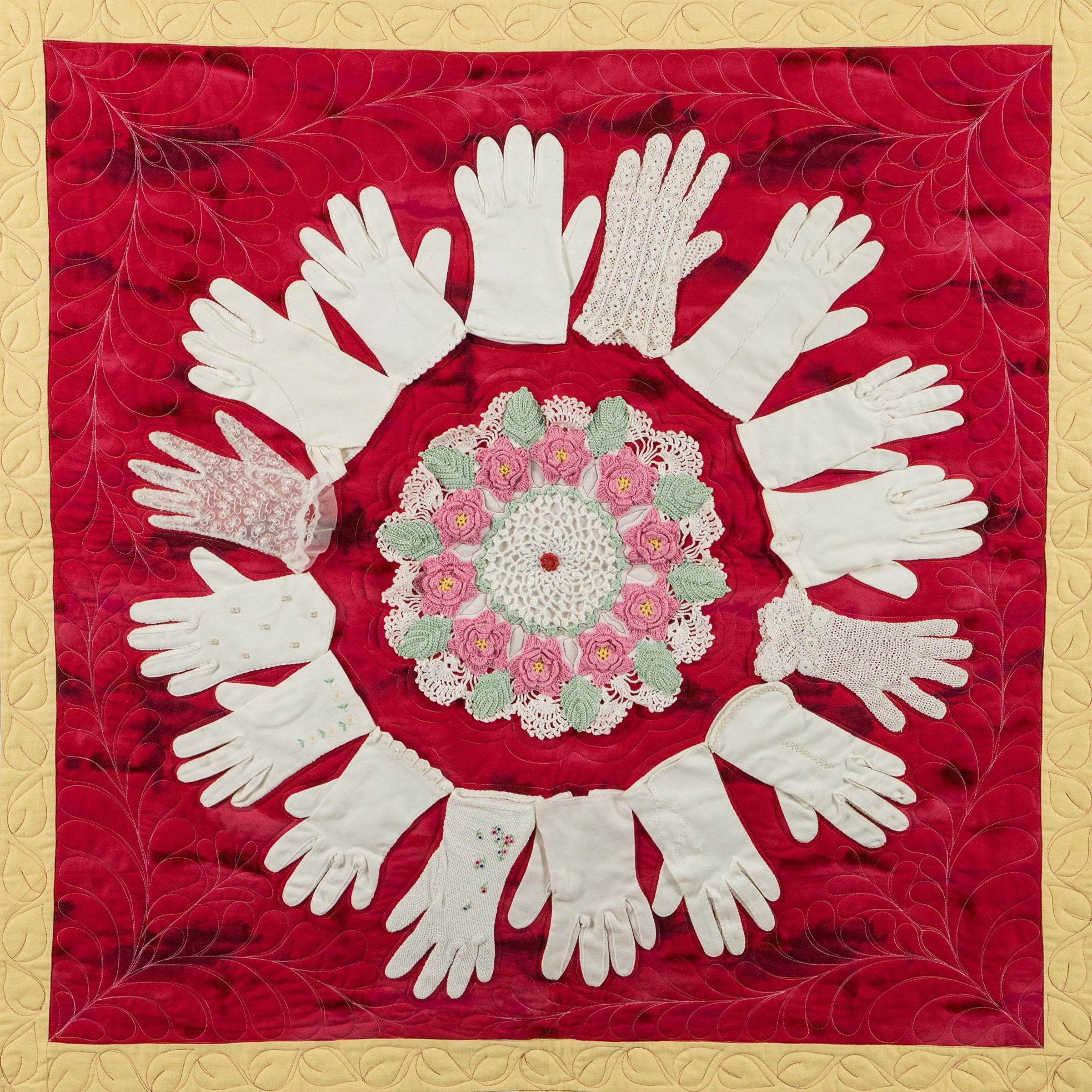 Artistic arrangement of white gloves and floral center on a red background with gold border