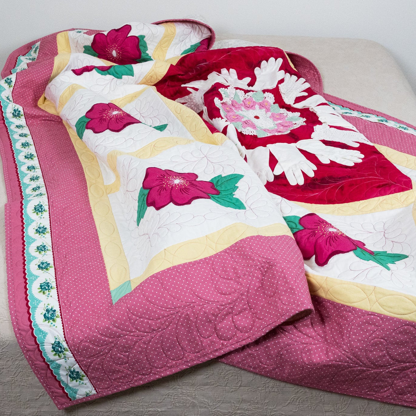 Floral quilt with pink and white flowers on a bed