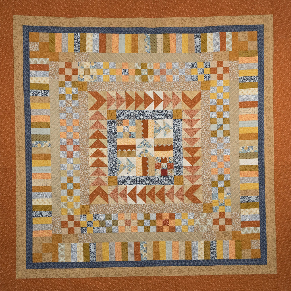 Patchwork quilt with geometric patterns in earthy tones