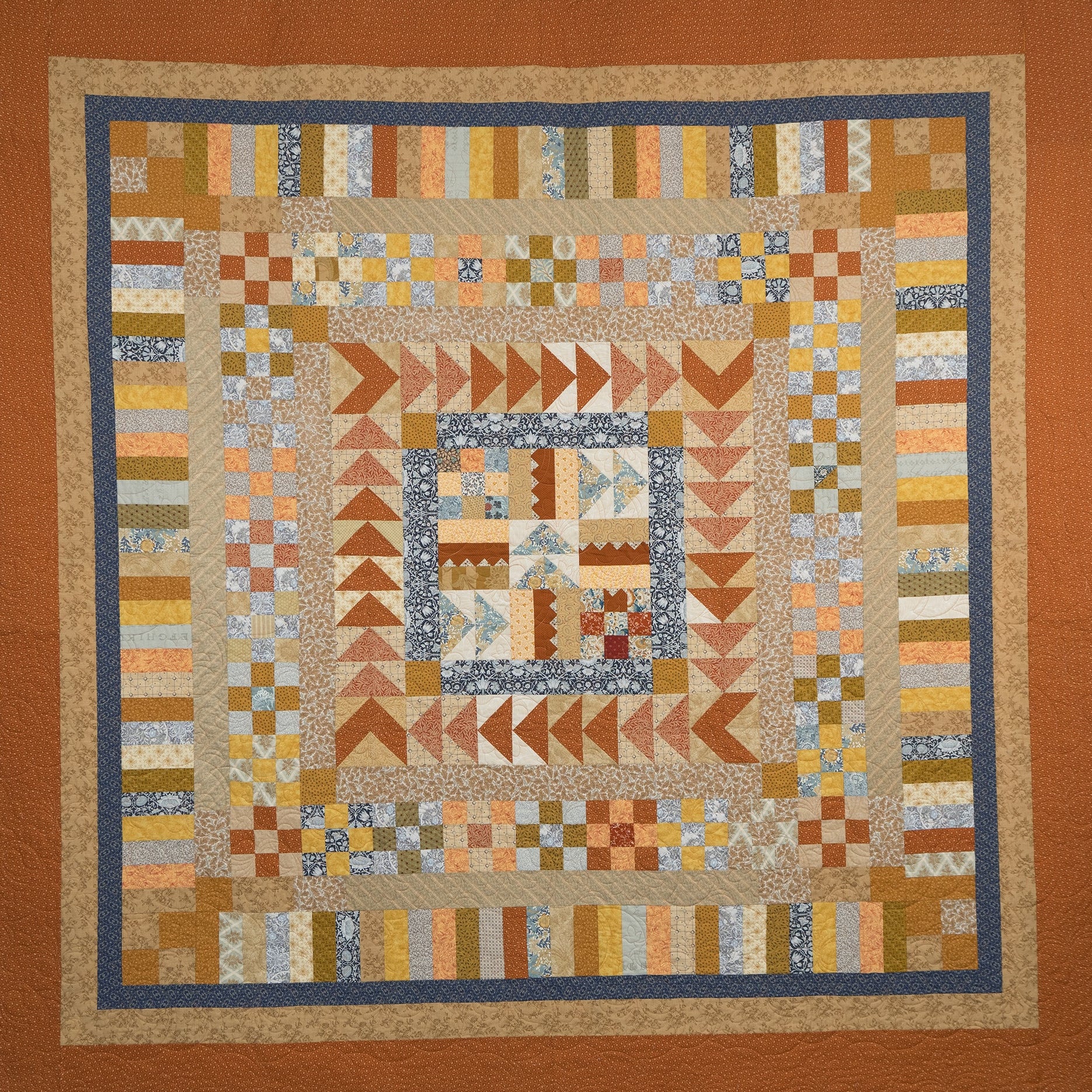 Patchwork quilt with geometric patterns in earthy tones