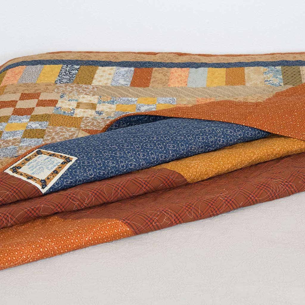 Quilt with a geometric pattern on a white background
