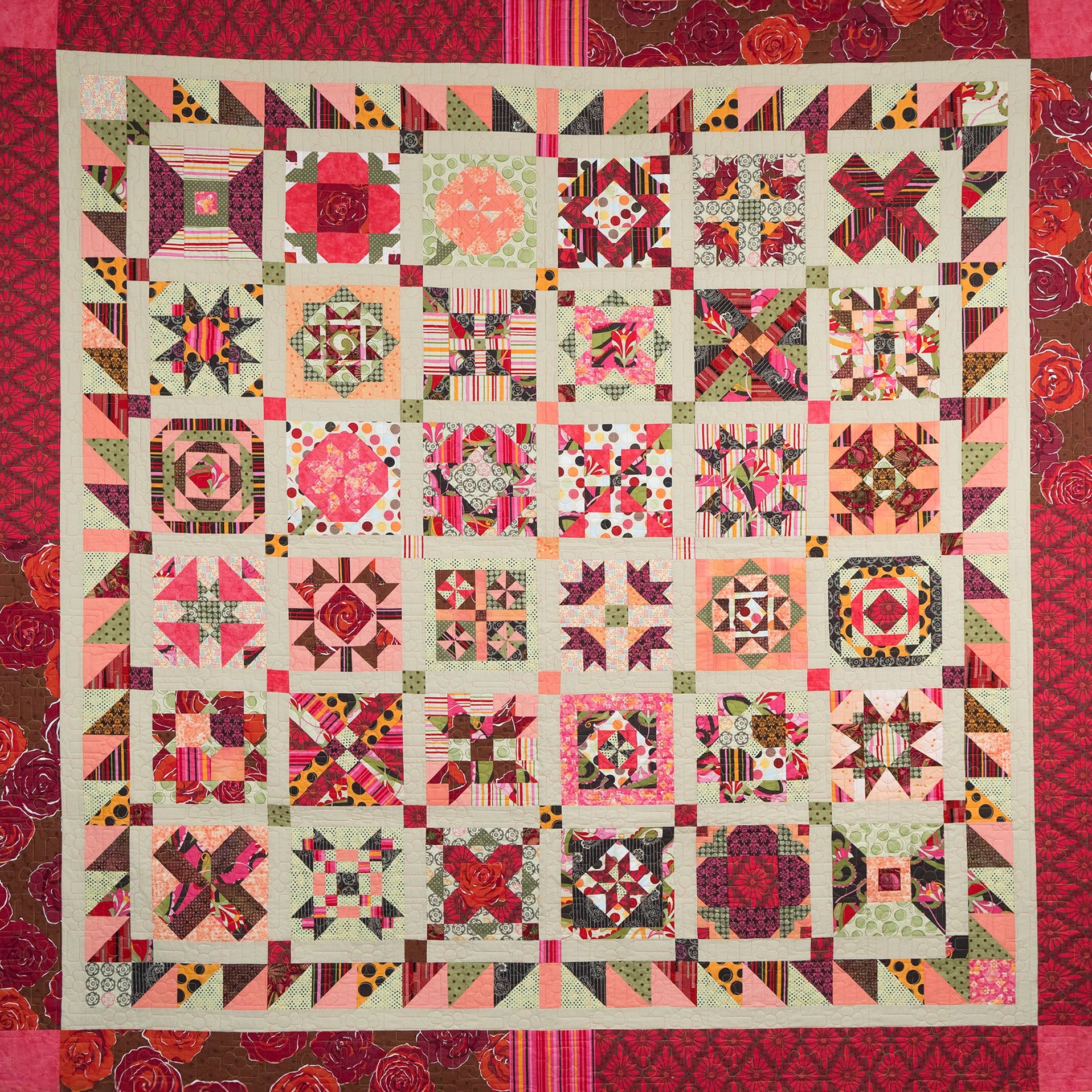 Colorful quilt with geometric patterns and a red border