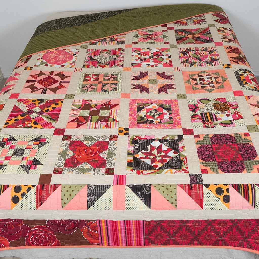 Colorful patchwork quilt on a bed with a plain background