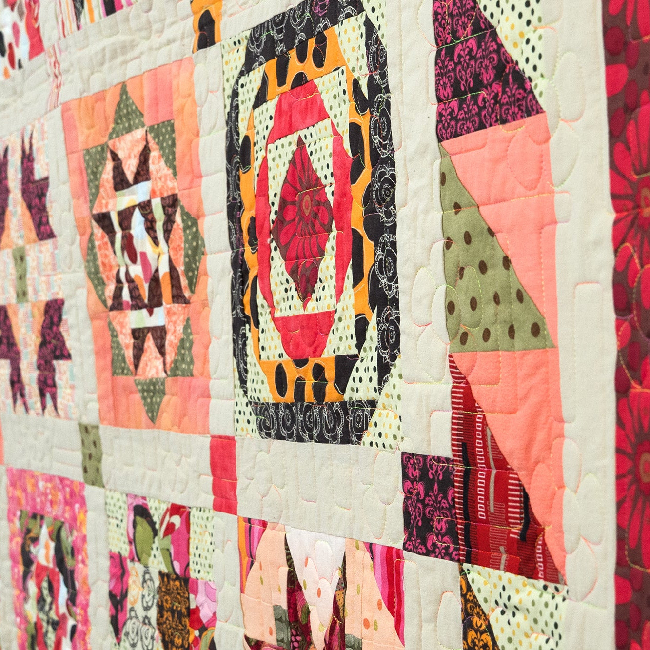 Colorful patchwork quilt with geometric and floral patterns.
