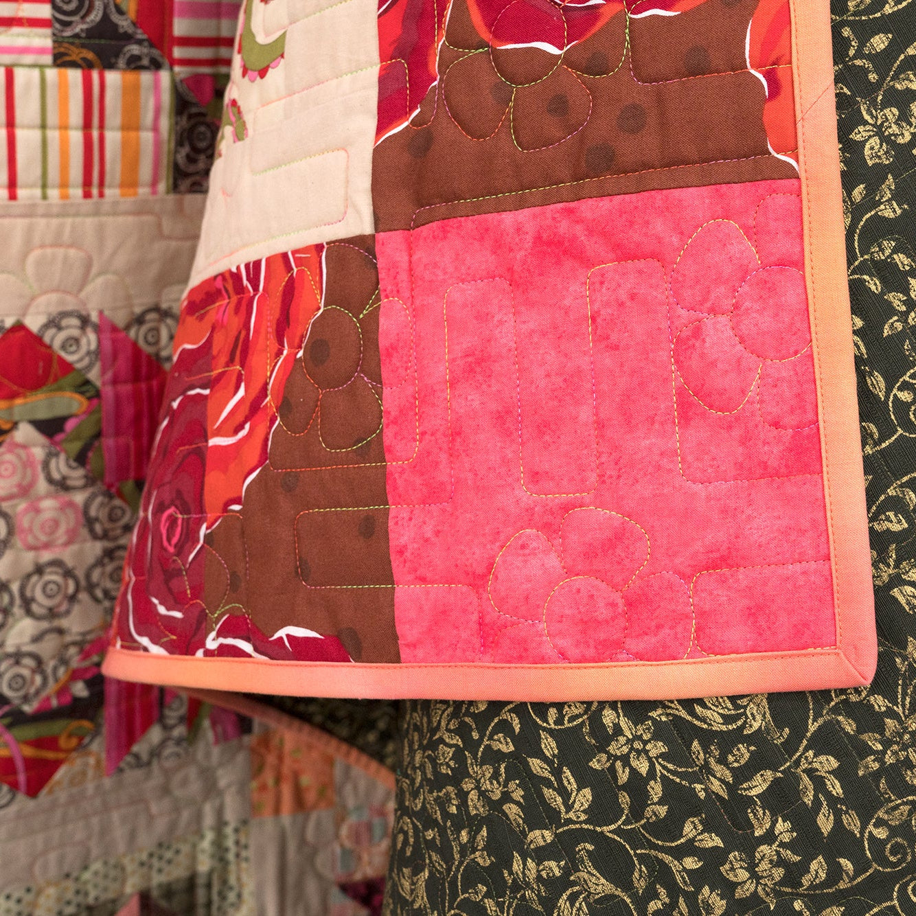Close-up of a colorful quilt with various patterns and colors.
