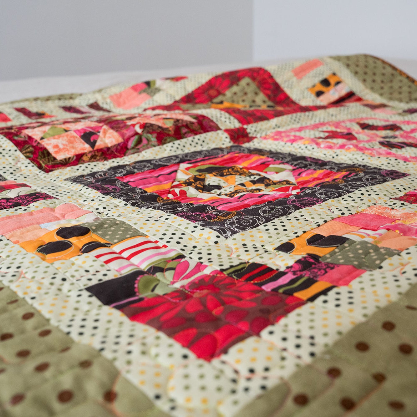 Quilt with colorful patchwork design on a white background