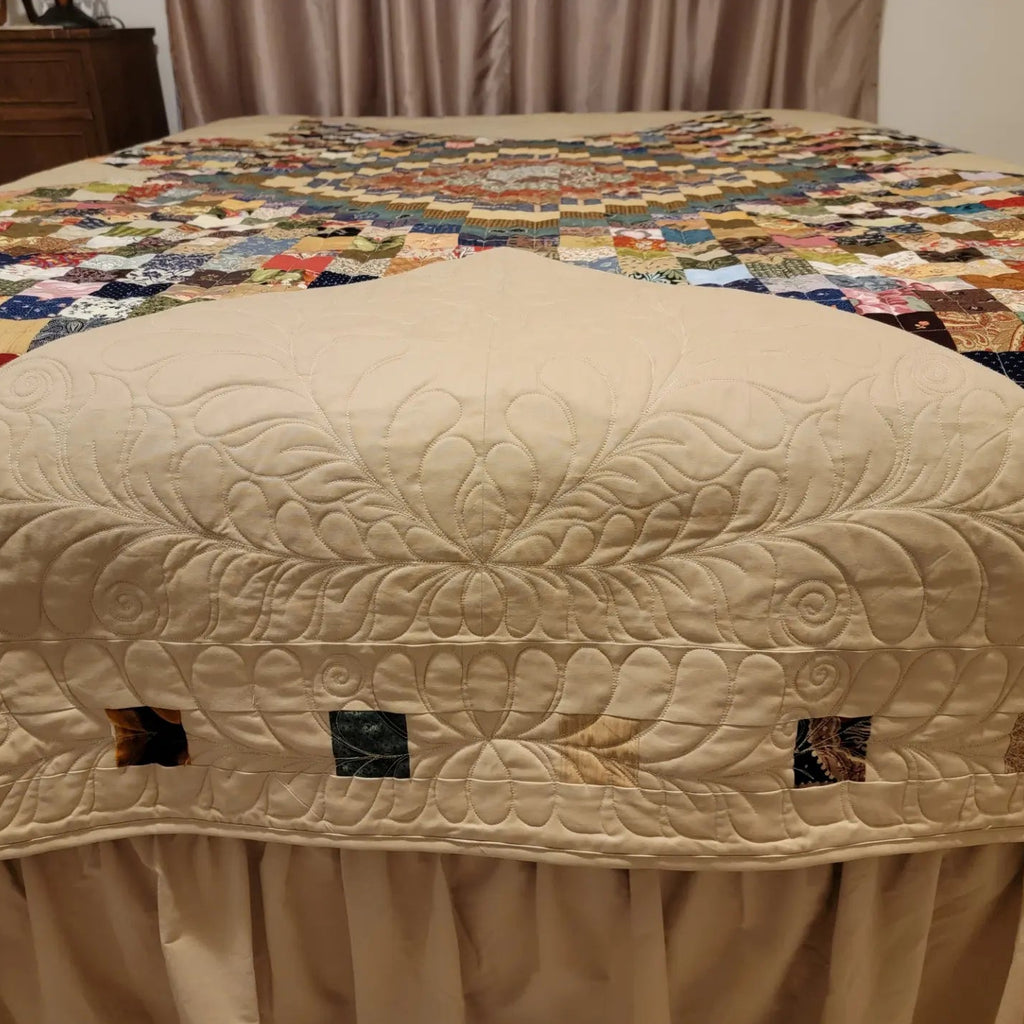 Beige quilt on a bed
