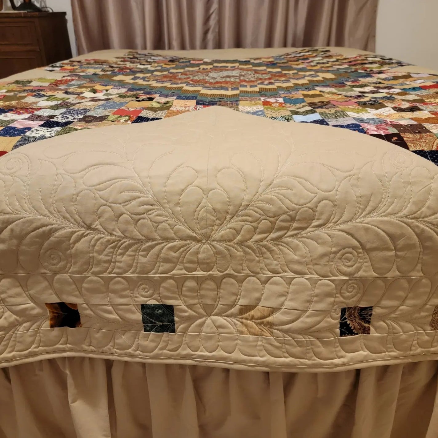 Beige quilt on a bed