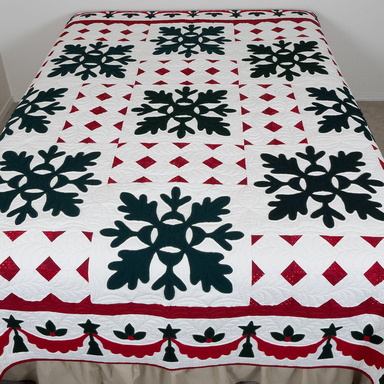 Quilt with black snowflake design on a white background