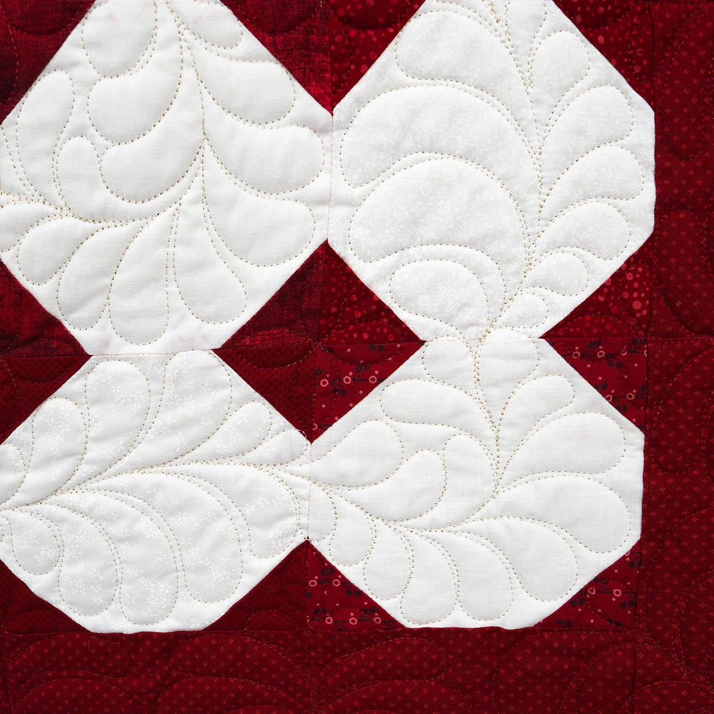 Quilt with red and white diamond pattern