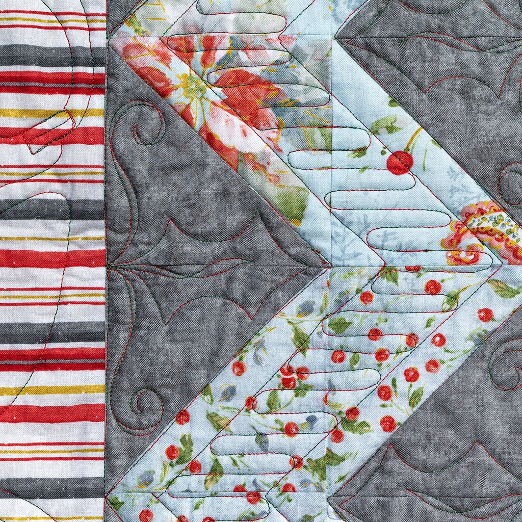 Quilt block with floral and striped patterns on a gray background