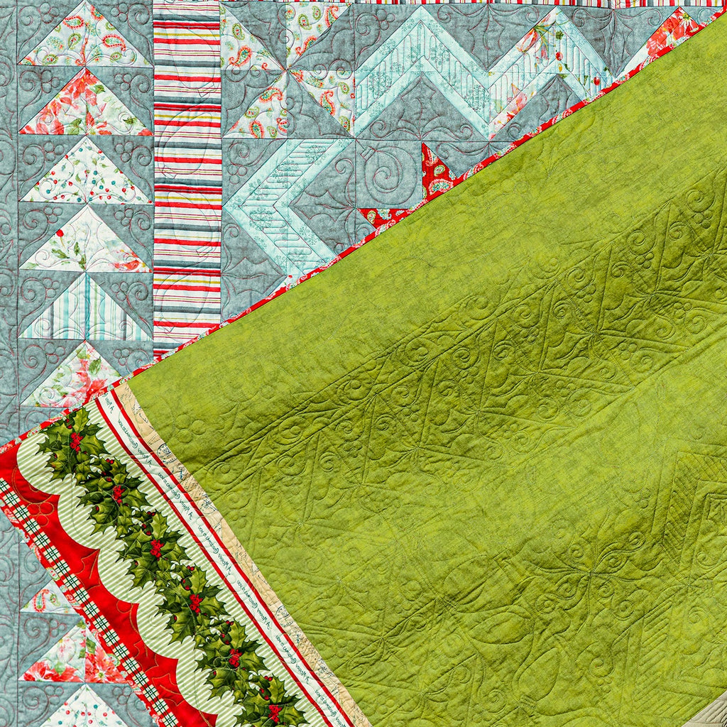 Quilt with green fabric and colorful geometric patterns