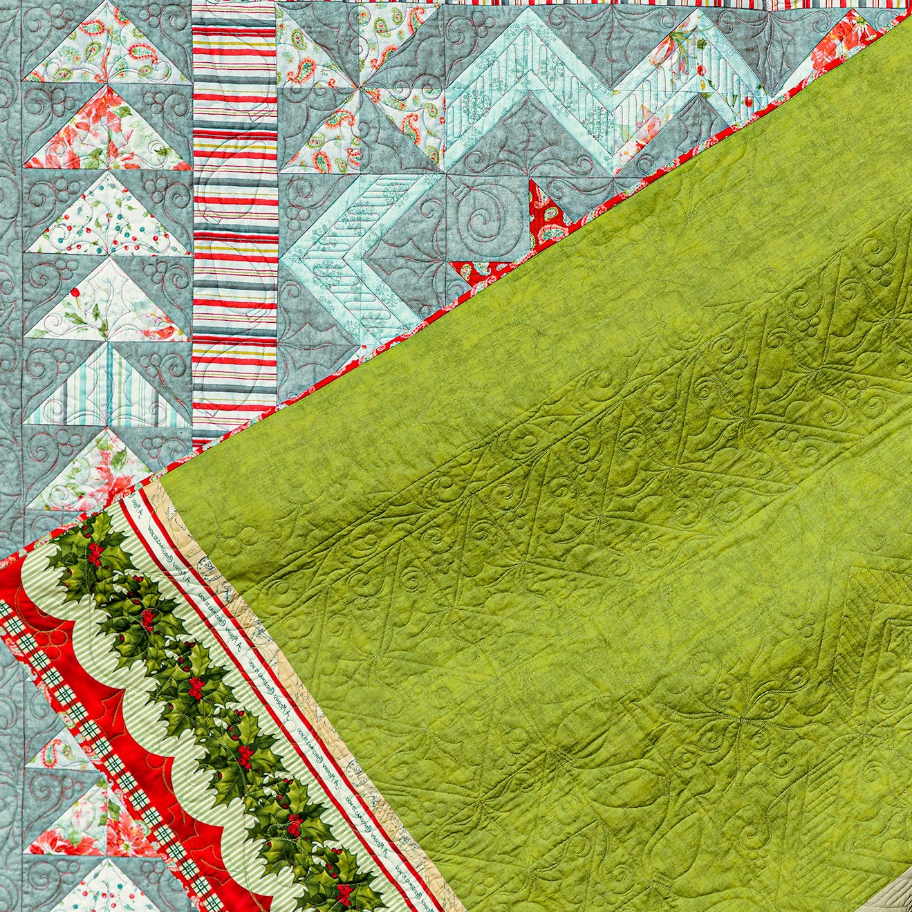 Quilt with green fabric and colorful geometric patterns