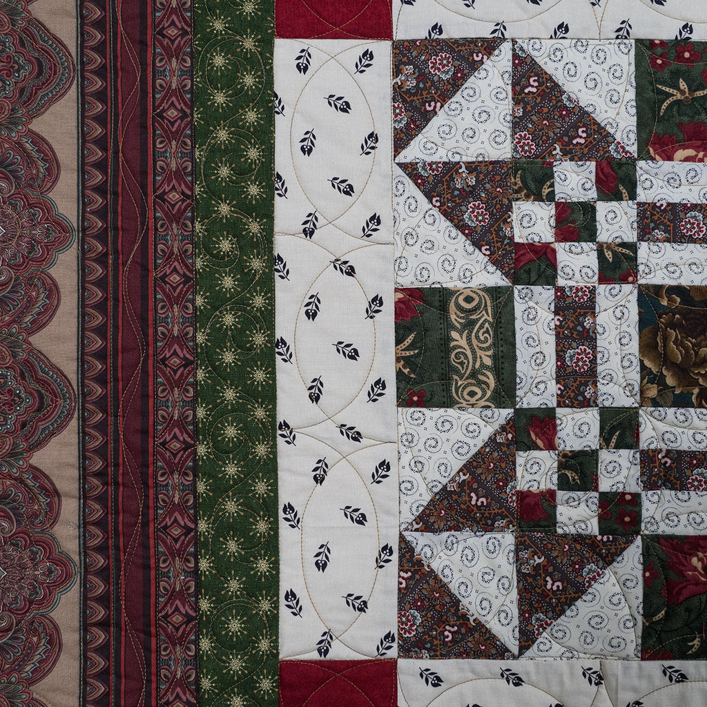 Quilt close up of various prints in green, red and white