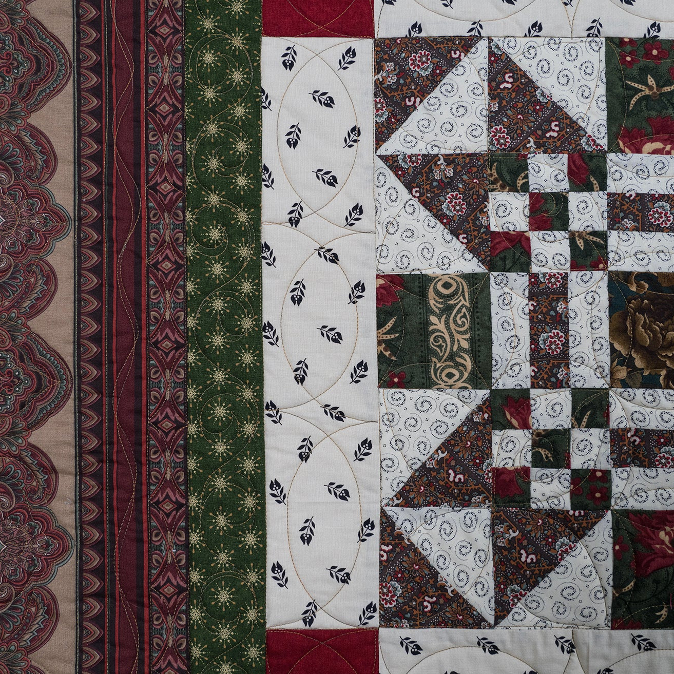 Quilt close up of various prints in green, red and white