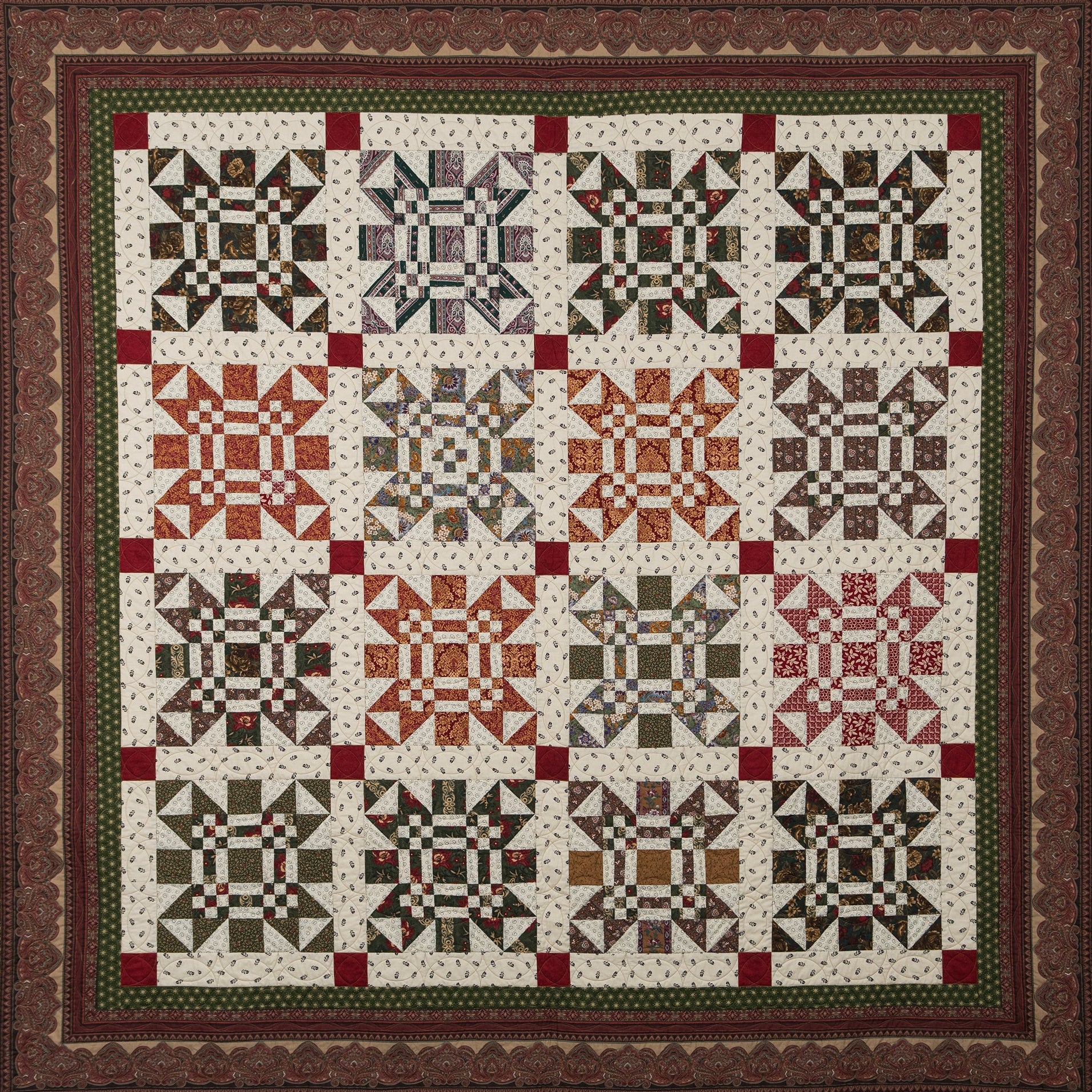 Missouri print quilt in green, orange, red and neutral tones