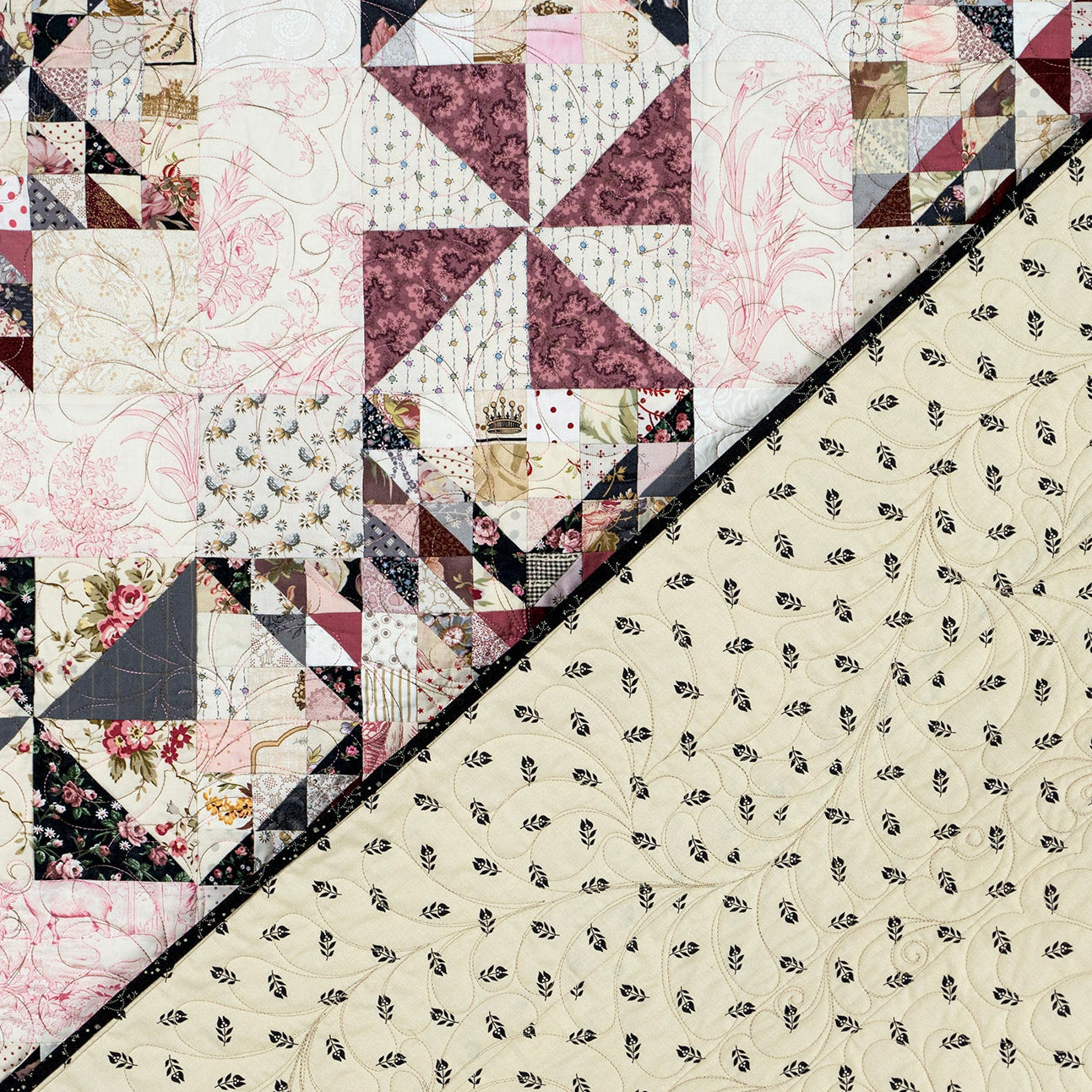 A close-up of a quilted fabric panel with a diagonal split. The top-left section shows a patchwork quilt design with floral and geometric blocks in cream, burgundy, black, and beige.