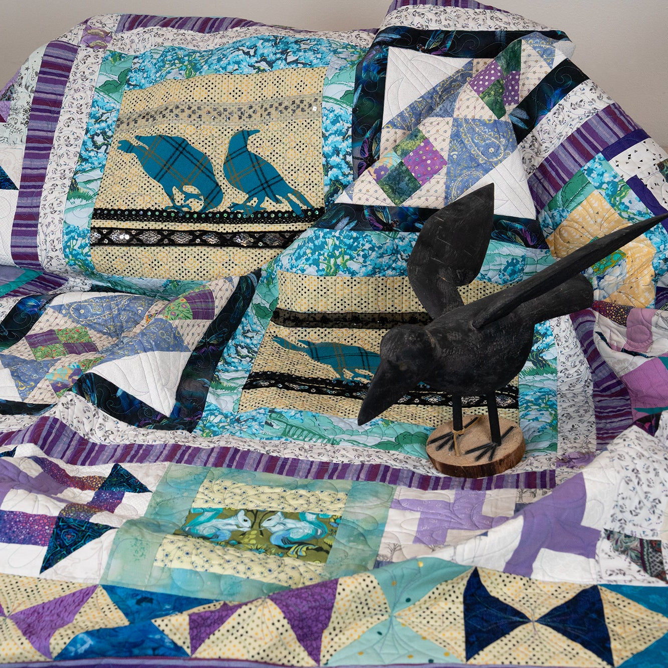 Quilt with bird design on a bed