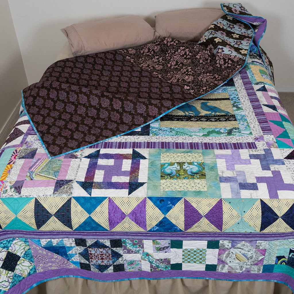 Colorful patchwork quilt on a bed with a plain background