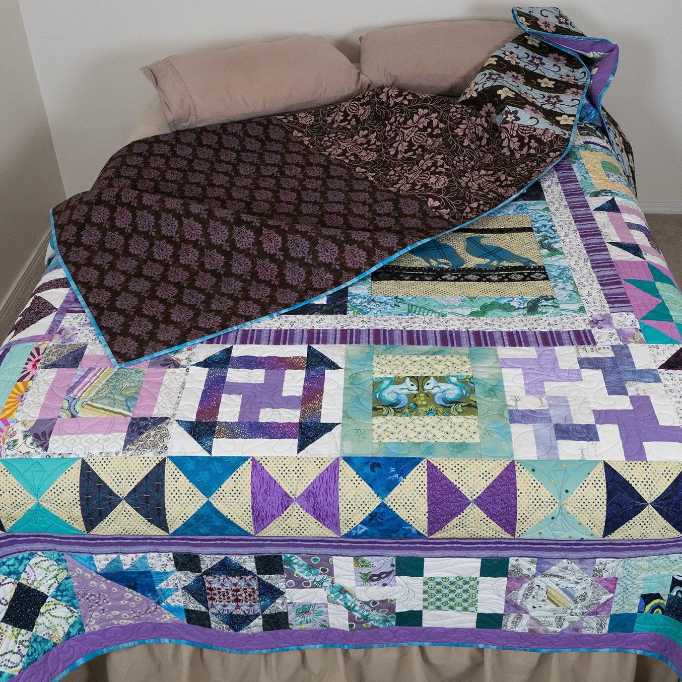 Colorful patchwork quilt on a bed with a plain background