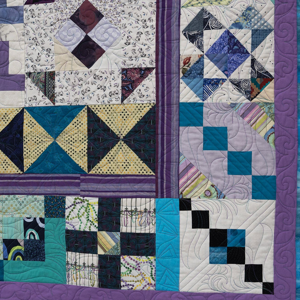 Quilt with geometric pattern in various colors