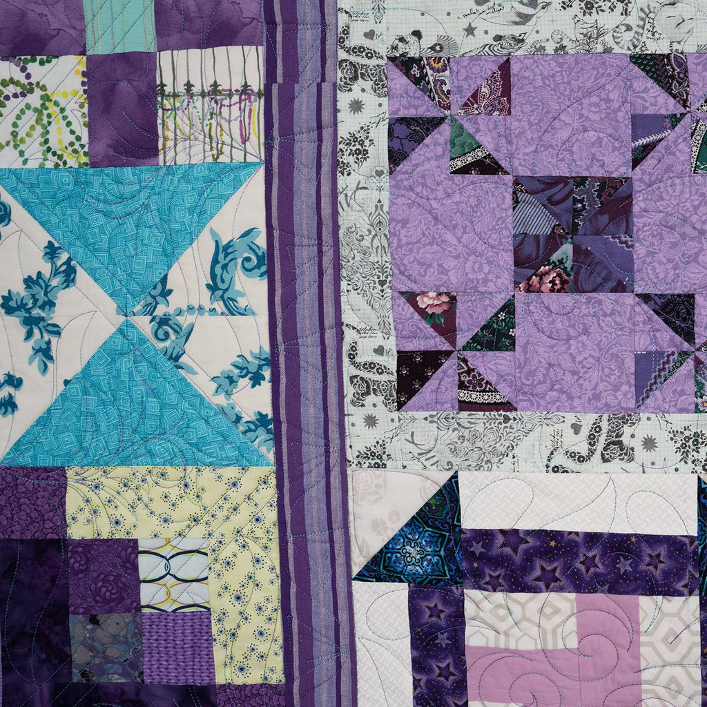 Close-up of a patchwork quilt with various patterns and colors.