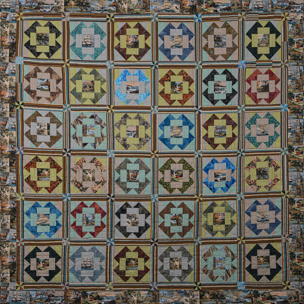 A handmade quilt featuring a grid of 36 square blocks, each with a central patch of vintage newspaper clippings surrounded by geometric star and diamond patterns in various colors like blue, green, red, brown, and beige.