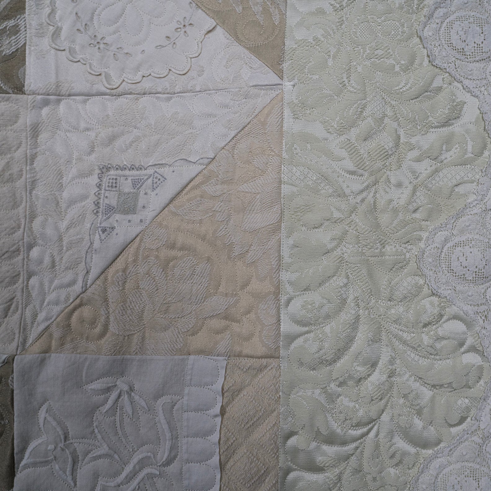 Patterned fabric with various textures and designs in neutral colors.