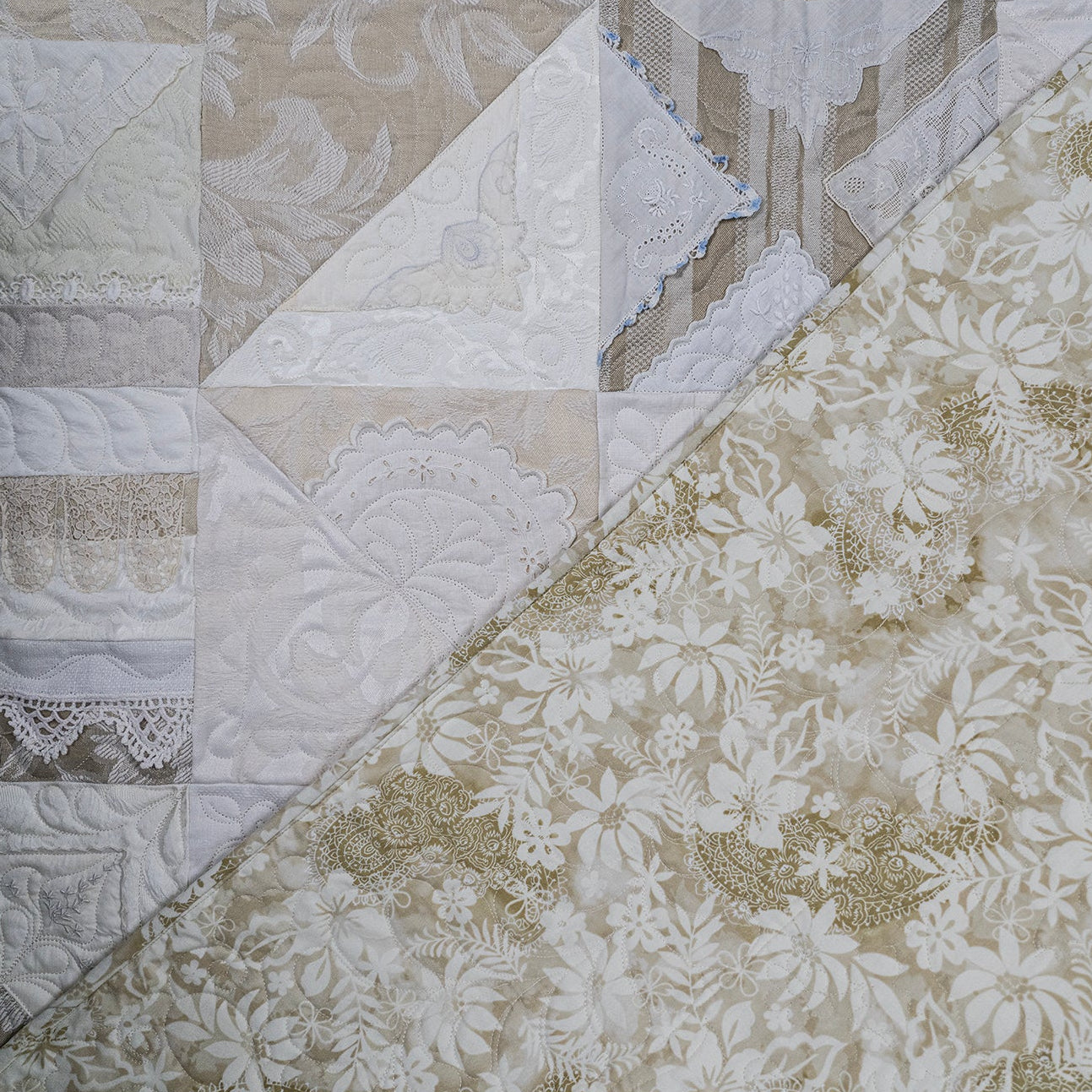 Patchwork quilt with floral and geometric patterns in neutral colors