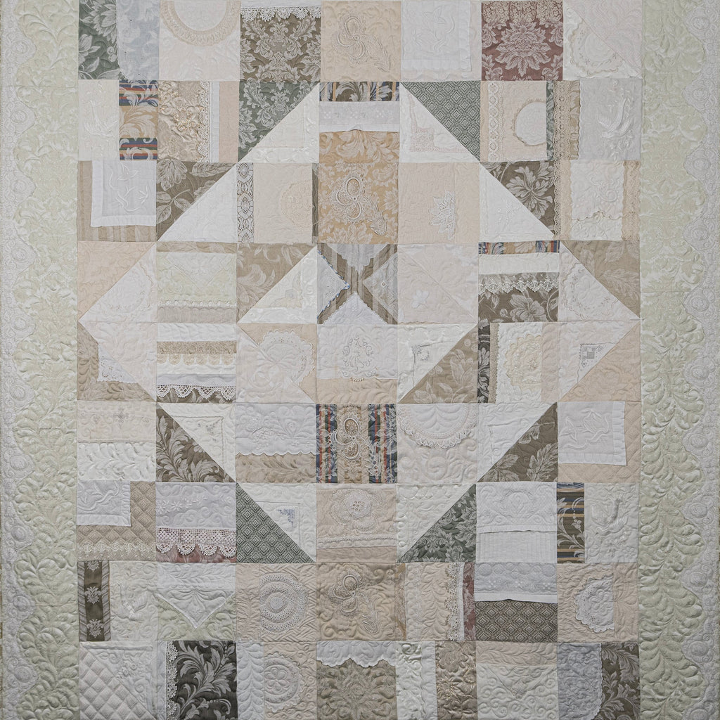Patchwork quilt with geometric pattern on a white background