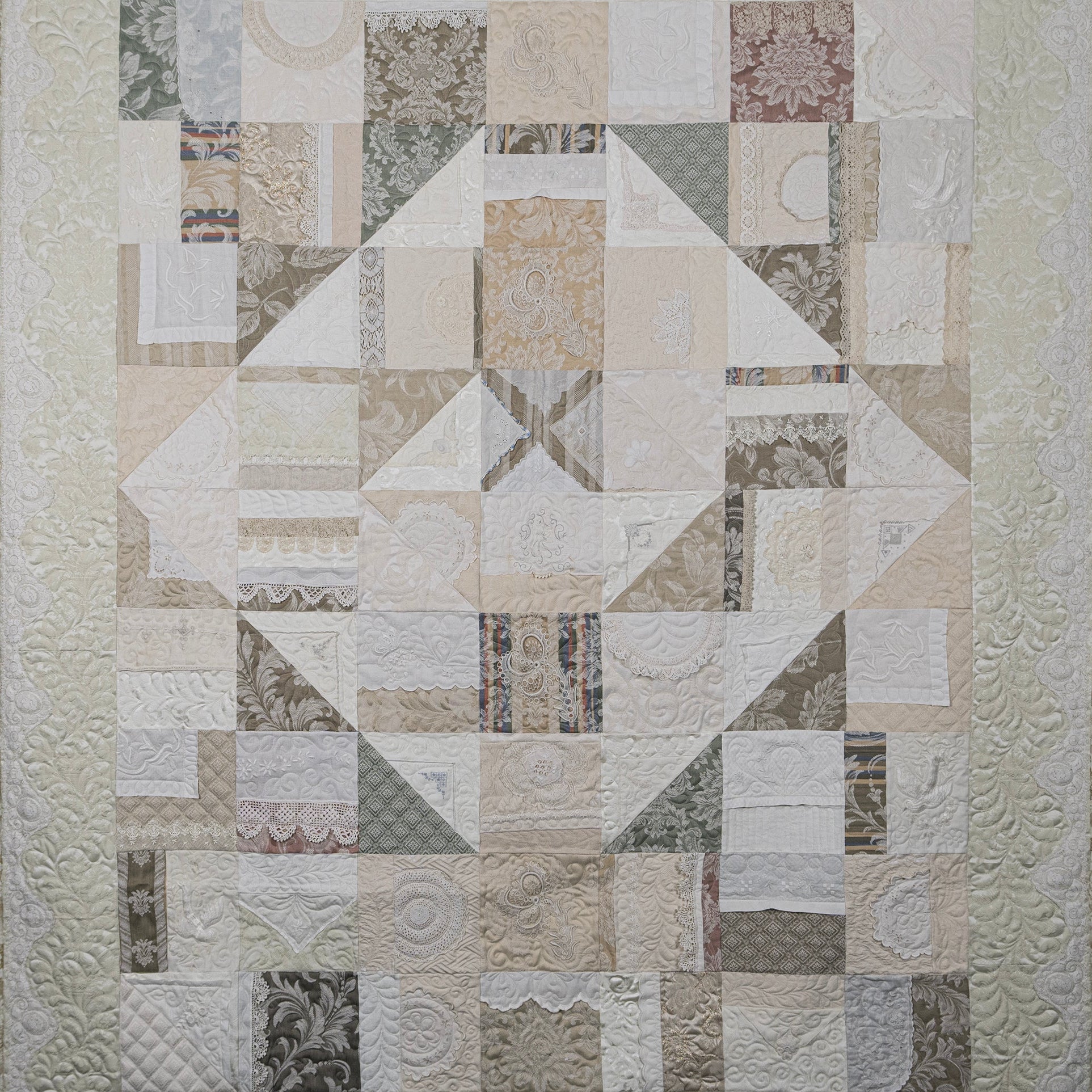 Patchwork quilt with geometric pattern on a white background