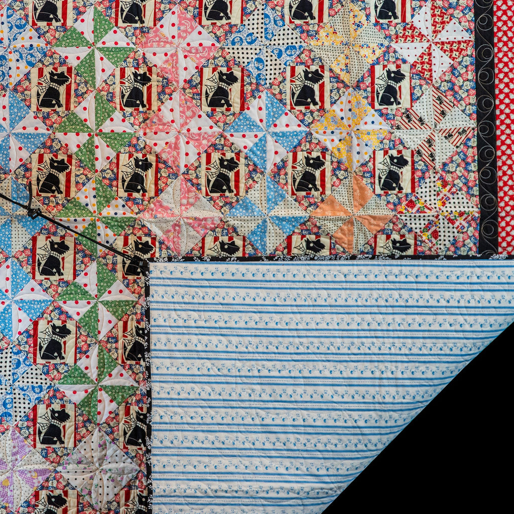 Colorful quilt with black dog pattern on a black background