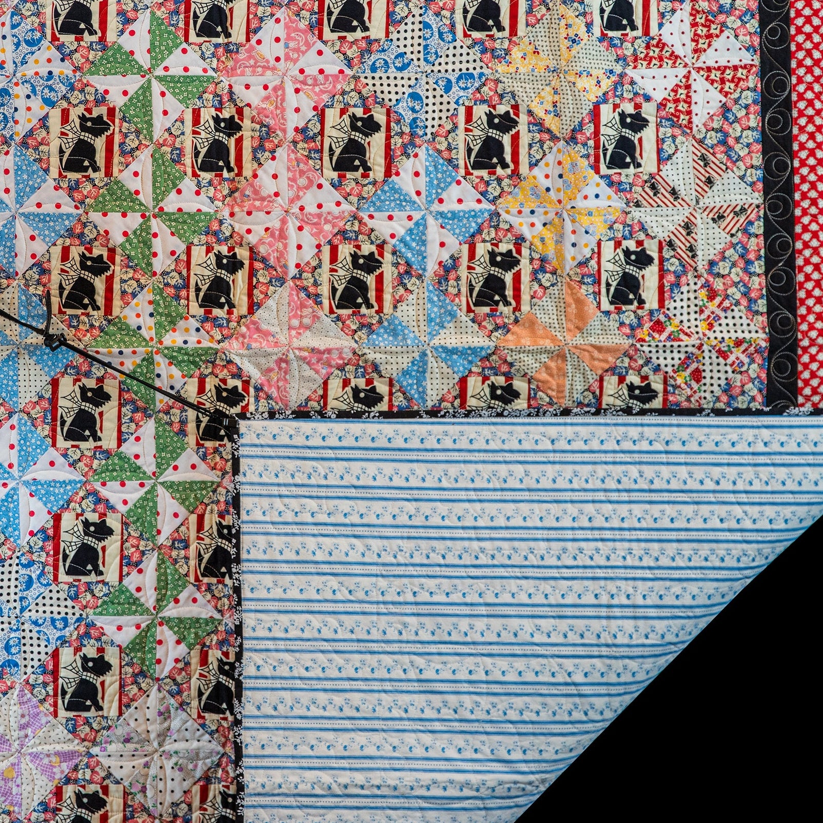 Colorful quilt with black dog pattern on a black background