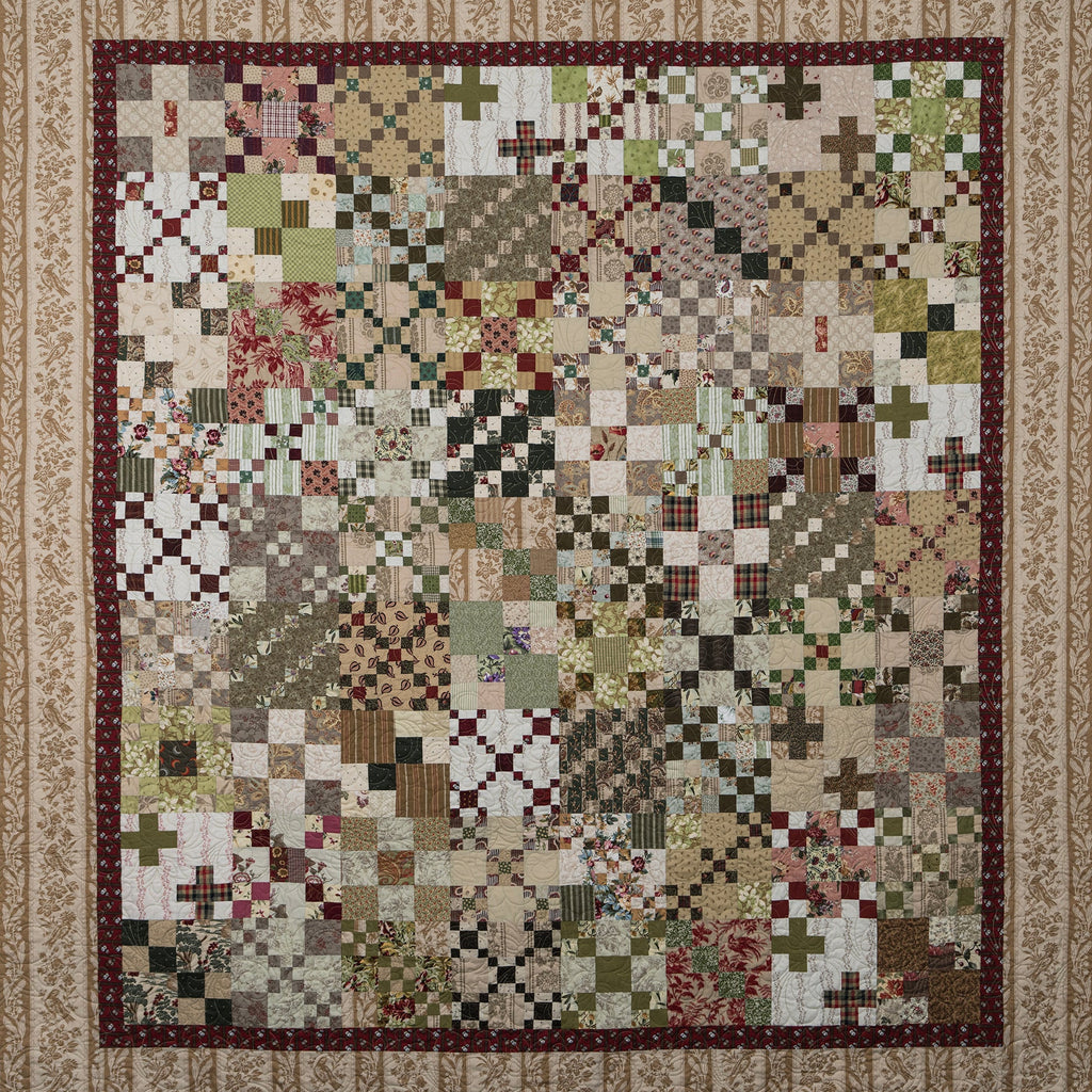 Patchwork quilt with a geometric pattern on a beige background