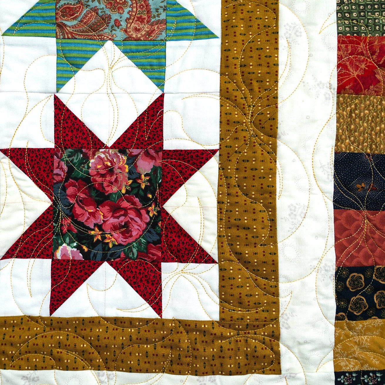 Quilt with floral star design and various patterns