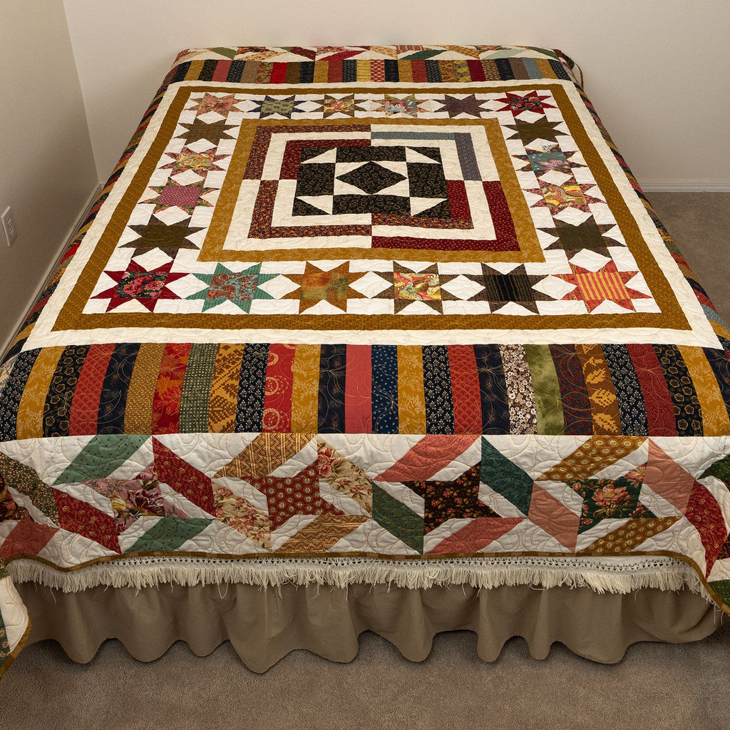 Colorful quilt with geometric pattern on a bed in a room.
