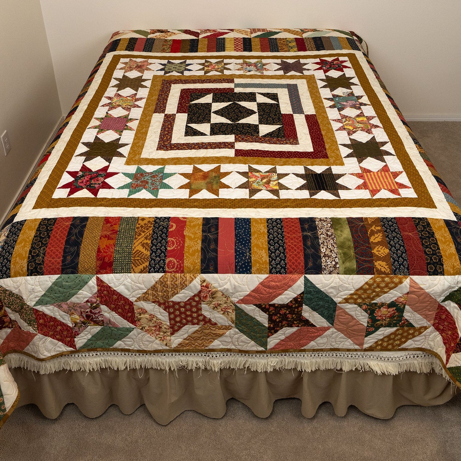 Colorful quilt with geometric pattern on a bed in a room.