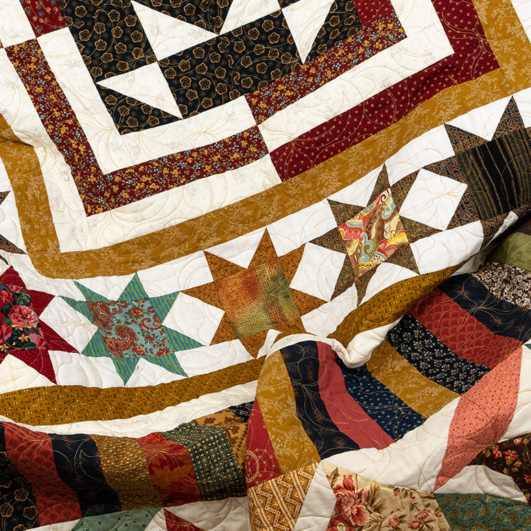 Colorful quilt with star patterns and various textures