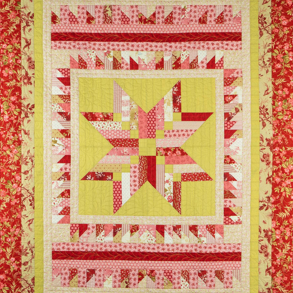 Quilt with star pattern in red, yellow, and white on a red floral border